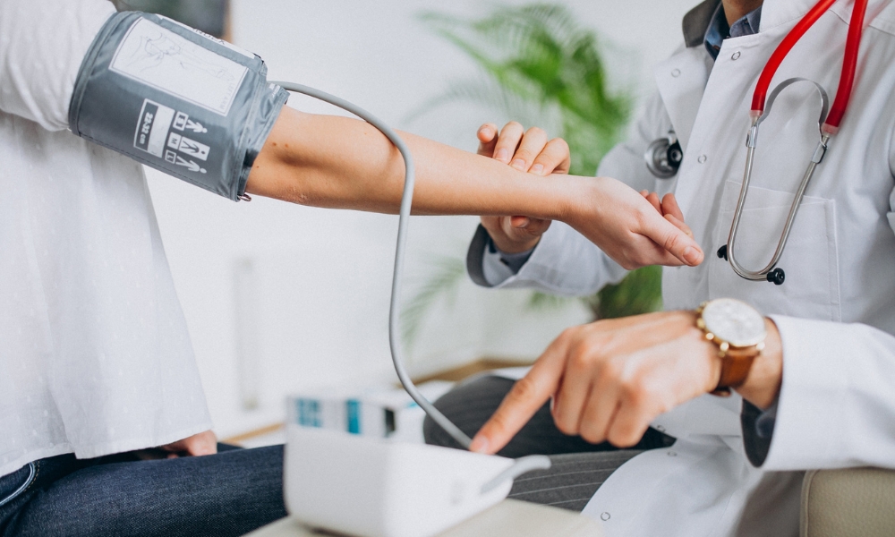 Primary care provider discussing hypertension treatment and healthy lifestyle changes with a patient